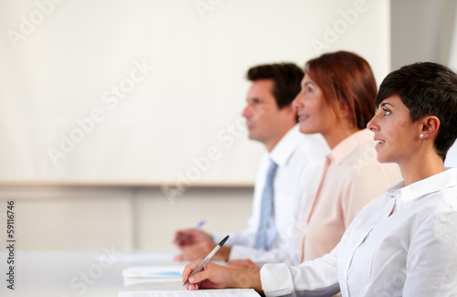 Hispanic colleagues listening to a conference