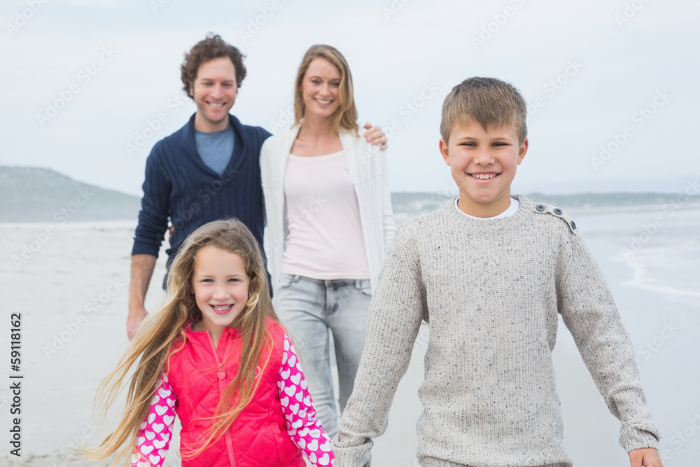 Happy family of four at the beach