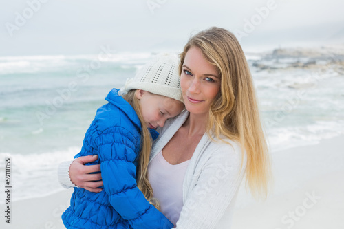 Young woman carrying little girl at beach © lightwavemedia