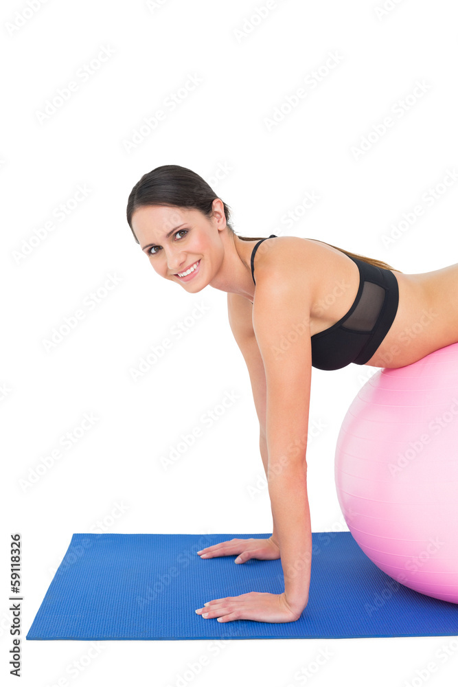 Side view portrait of a woman stretching on fitness ball Side view portrait of a woman stretching on fitness ball