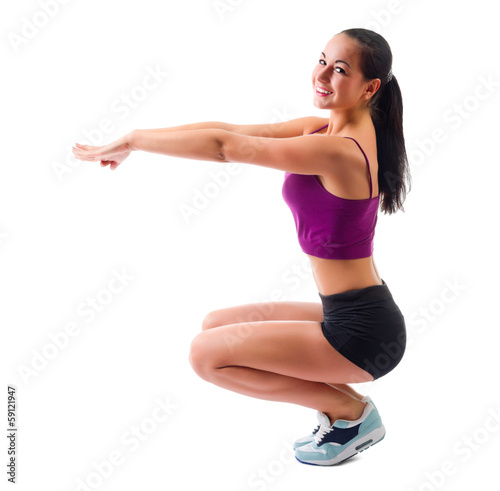 Young sporty woman doing gymnastic exercises