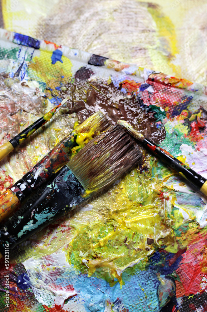 Beautiful vivid art palette and mix of paintbrushes Beautiful vivid art palette and mix of paintbrushes