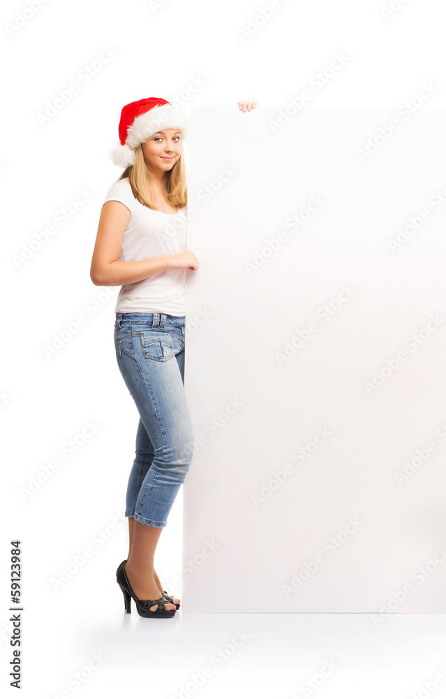 A happy teenage girl in a Christmas hat holding a large banner A happy teenage girl in a Christmas hat holding a large banner