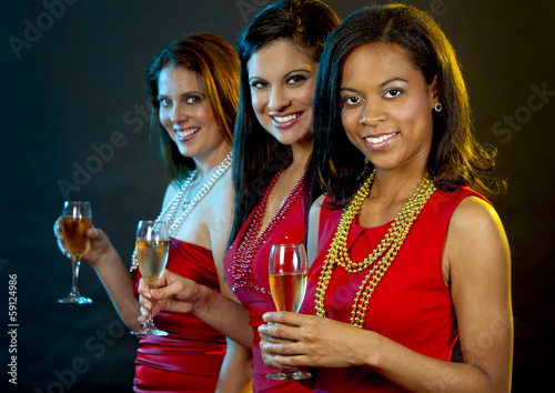 women holding champagne glasses