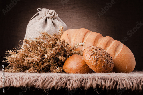 Bread, flour sack and ears bunch still life