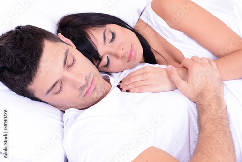 Couple in love sleeping in bed