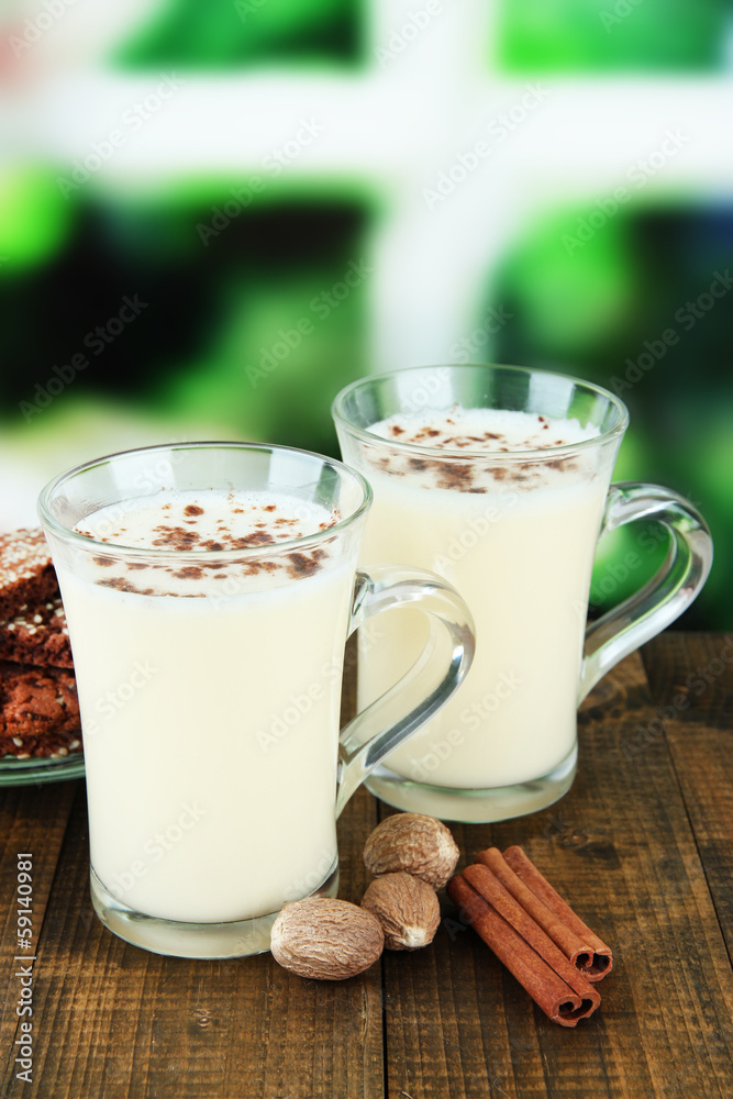Cups of eggnog with cinnamon and nuts Cups of eggnog with cinnamon and nuts
