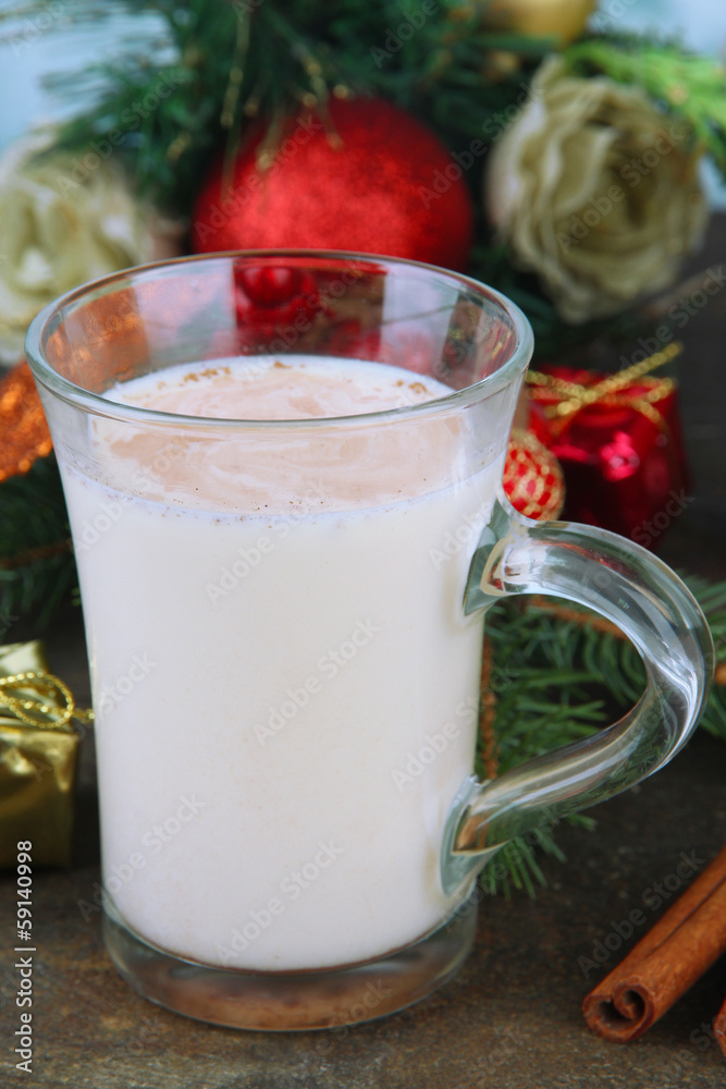 Cup of eggnog with fir branches and Christmas decorations close Cup of eggnog with fir branches and Christmas decorations close