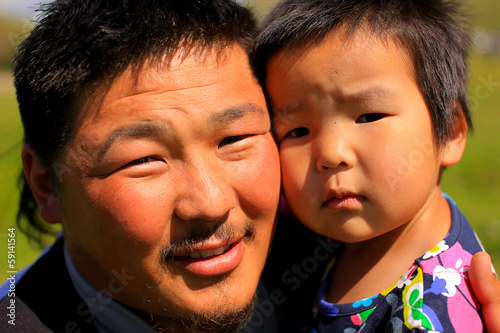 Mongolian man posing with his daughter