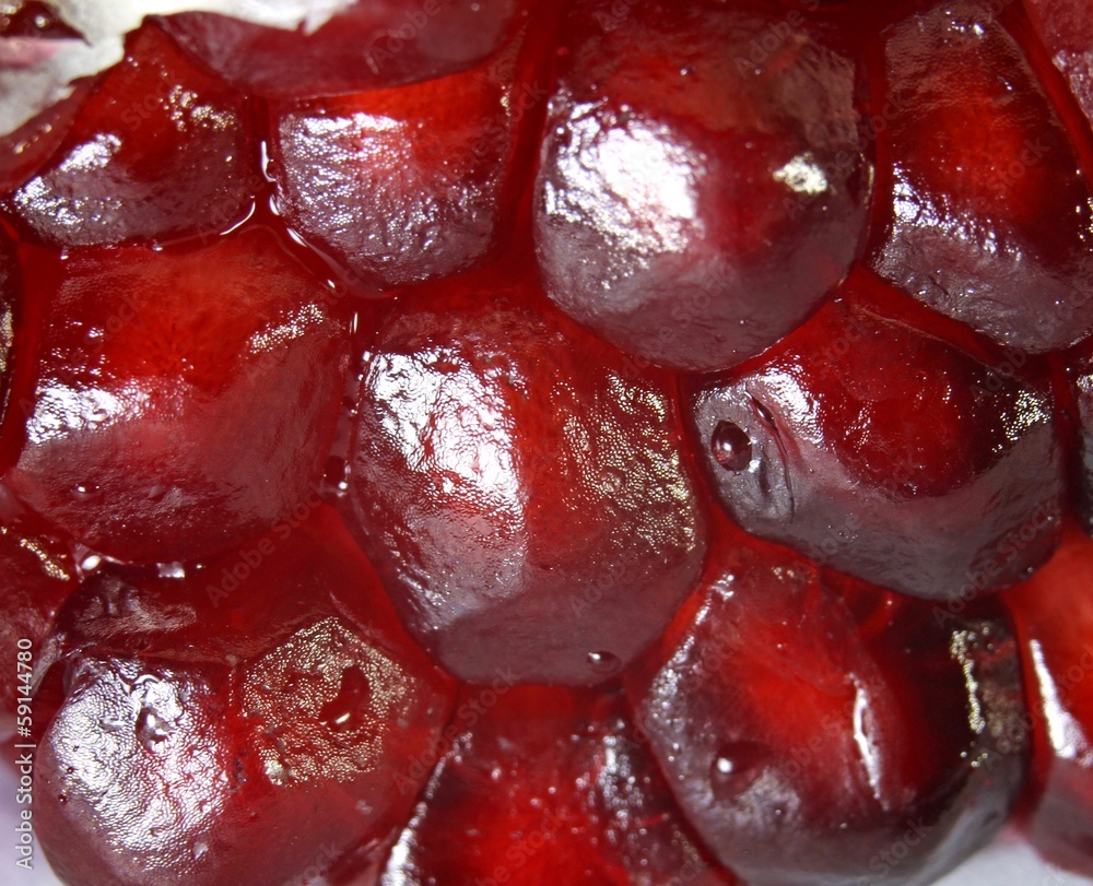 ripe pomegranate red with juicy seeds seen from very close ripe pomegranate red with juicy seeds seen from very close