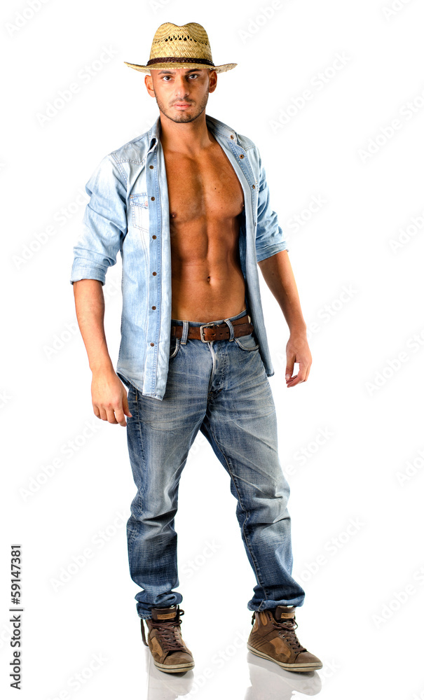 Handsome young man in jeans with straw hat Handsome young man in jeans with straw hat