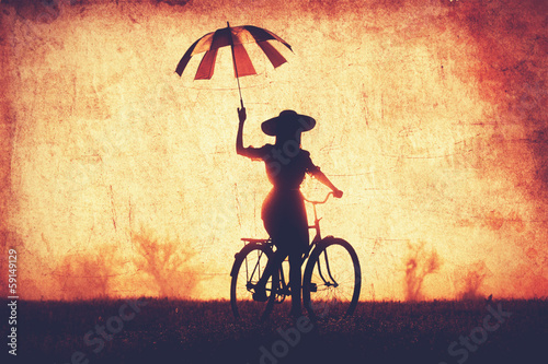 Wallpaper Mural Girl with umbrella on a bike in the countryside in sunrise time Torontodigital.ca