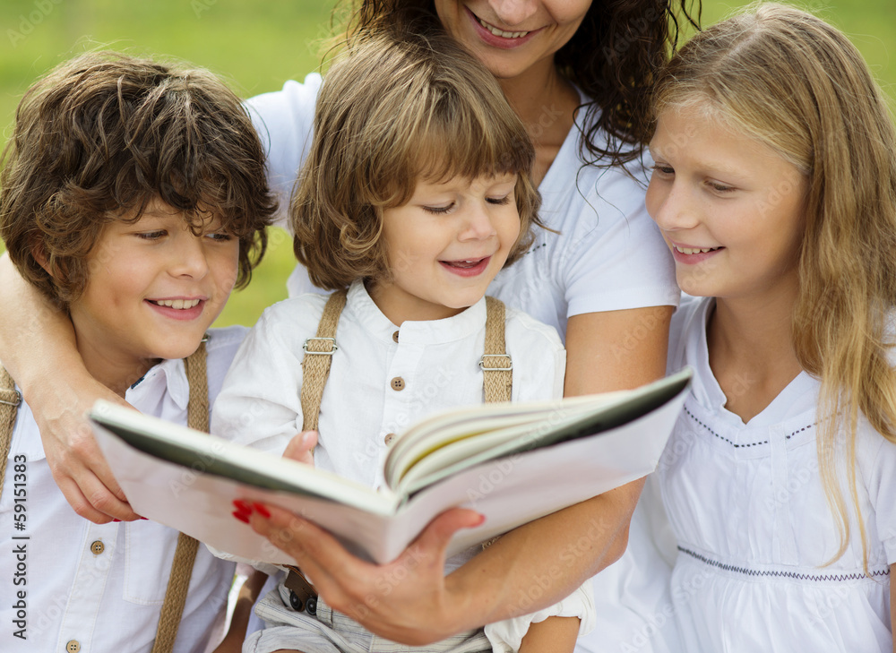 Mother and kids reading a book Mother and kids reading a book