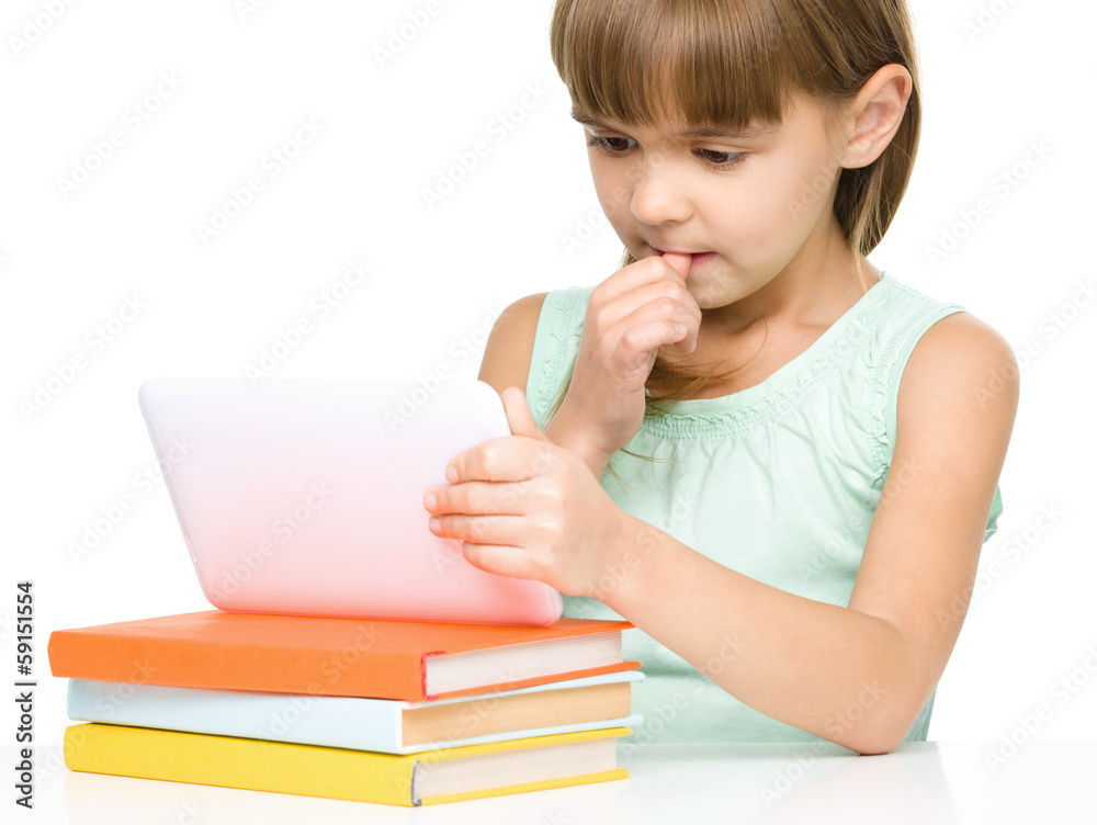 Young girl is using tablet while studying Young girl is using tablet while studying