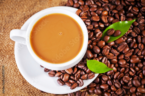 coffee cup and arabica beans on cloth sack