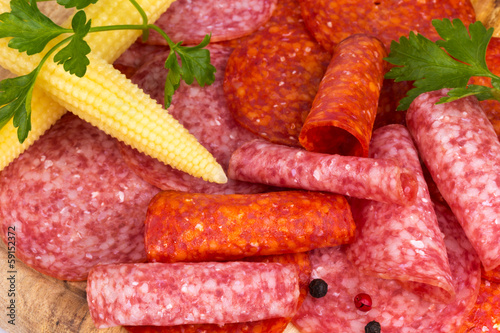 slices of salami with parsley and corn
