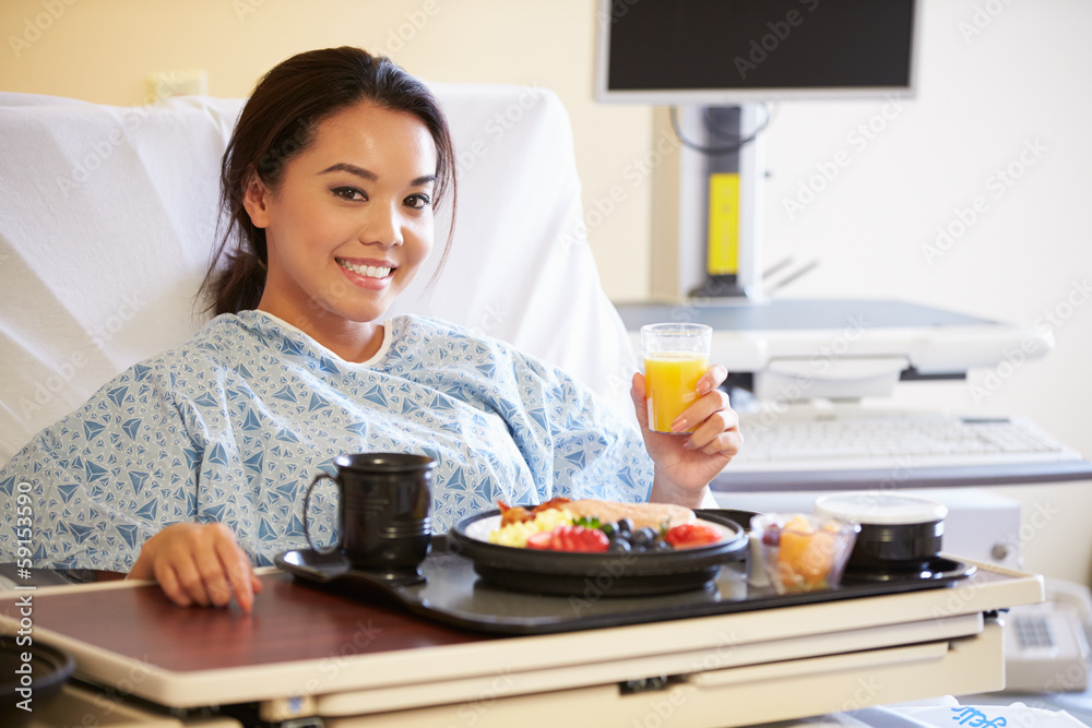 Female Patient Enjoying Meal In Hospital Bed Female Patient Enjoying Meal In Hospital Bed