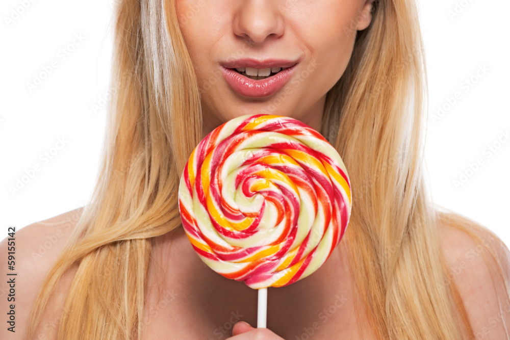 Closeup on happy teenage girl holding lollypop