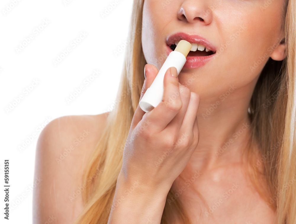 Closeup on happy teenage girl applying hygienic lipstick Closeup on happy teenage girl applying hygienic lipstick