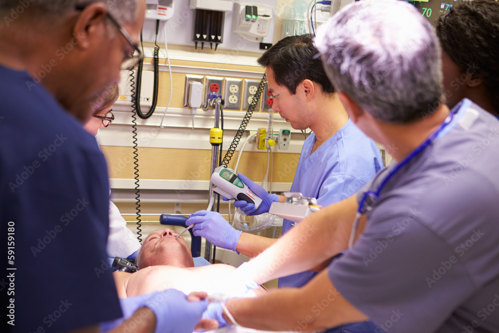 Medical Team Working On Patient In Emergency Room Medical Team Working On Patient In Emergency Room