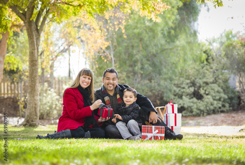 Mixed Race Family Enjoying Christmas Gifts in the Park Together © Andy Dean