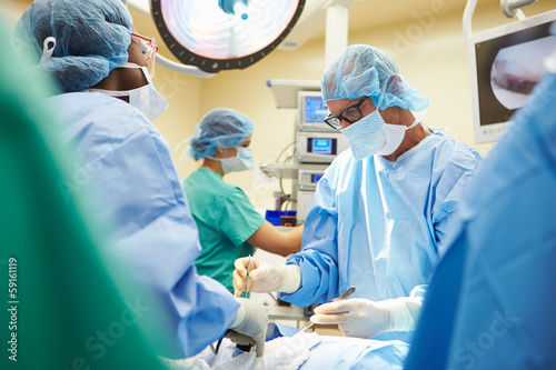 Surgical Team Working In Operating Theatre