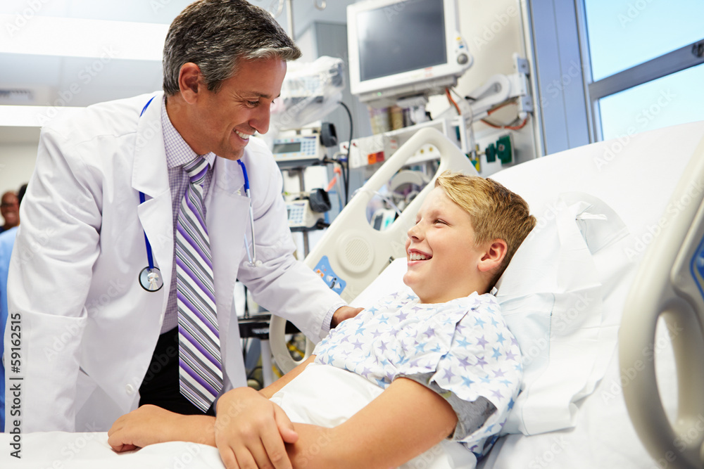 Boy Talking To Male Doctor In Emergency Room Boy Talking To Male Doctor In Emergency Room