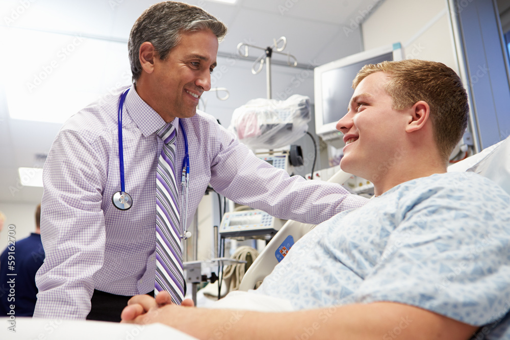 Fototapeta premium Young Male Patient Talking To Consultant In Emergency Room