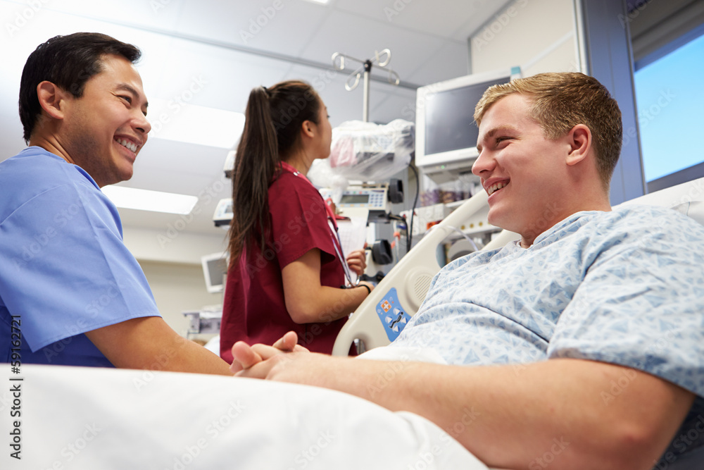 Male Patient Talking To Medical Staff In Emergency Room