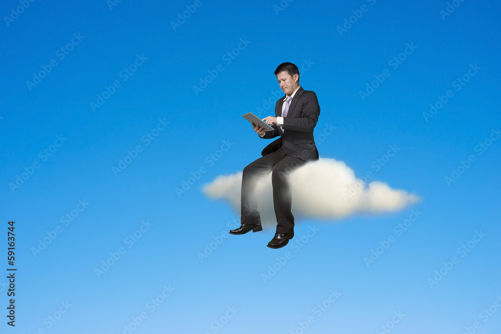Businessman using tablet and sitting on cloud Businessman using tablet and sitting on cloud