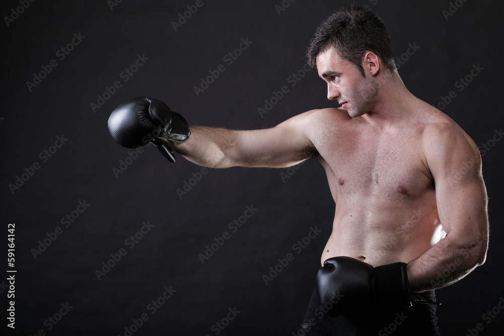 Portrait sportsman boxer in studio dark background Portrait sportsman boxer in studio dark background