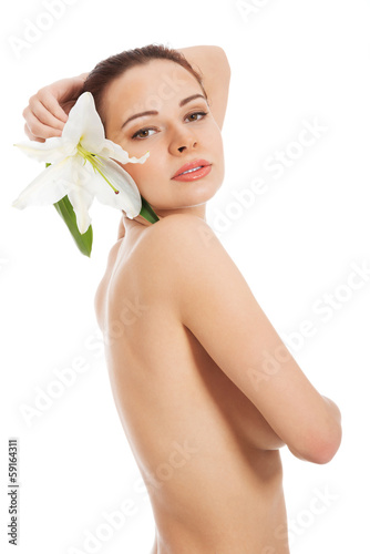 Beautiful topless woman with white lily.