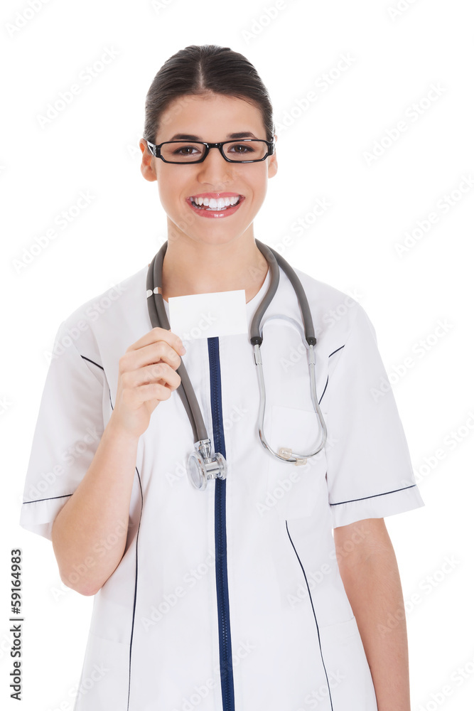 Young female doctor holding business card. Young female doctor holding business card.