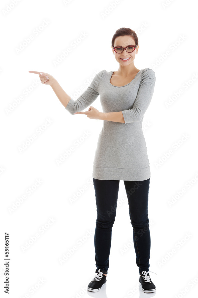 Beautiful casual woman in eyeglasses pointing aside. Beautiful casual woman in eyeglasses pointing aside.