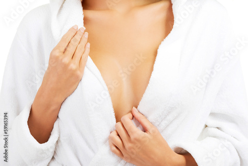 Woman in bathrobe, close up on chest.