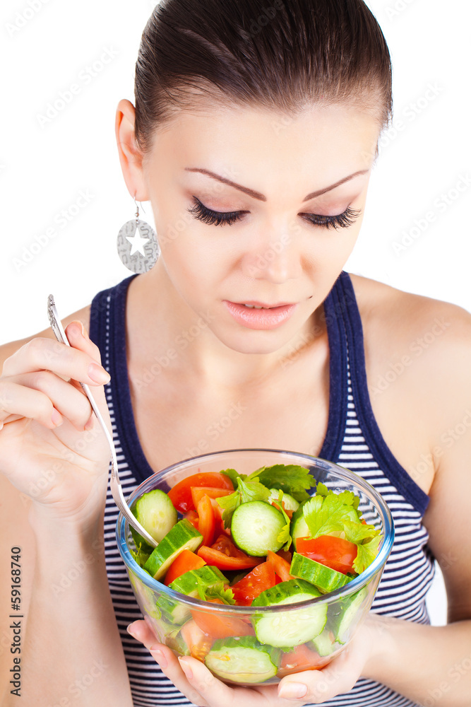 Young woman eating salad isolated portrait. Young woman eating salad isolated portrait.