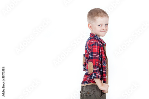 Portrait of happy boy with hands in pockets isolated on white ba