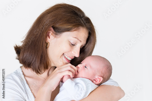 Young happy mother holding her newborn baby