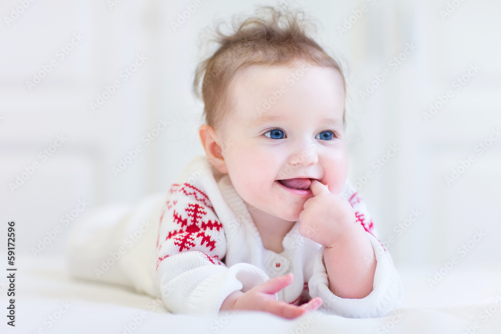Baby wearing a knitted sweater with red Christmas snowflake Baby wearing a knitted sweater with red Christmas snowflake