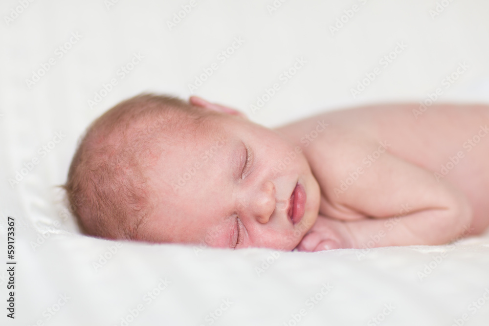 Little newborn baby sleeping on a warm knitted blanket Little newborn baby sleeping on a warm knitted blanket