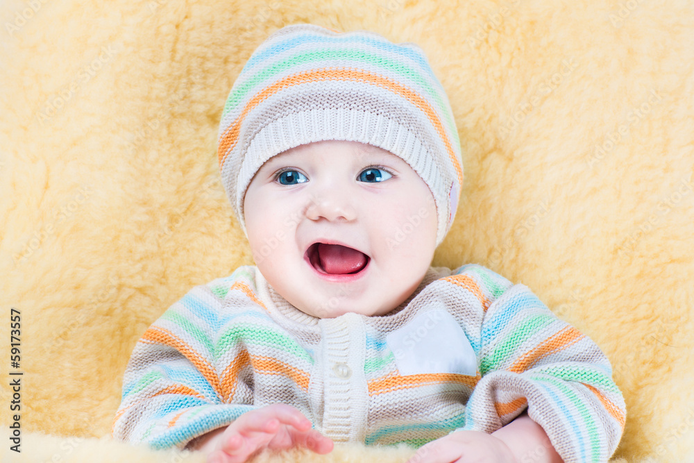 Happy little baby relaxing in a warm sheepskin stroller foot muf Happy little baby relaxing in a warm sheepskin stroller foot muf
