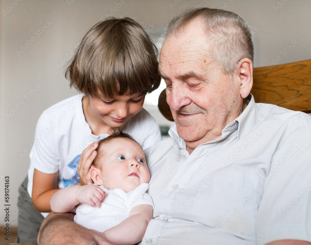 Great grandfather and a newborn baby girl next to his school boy