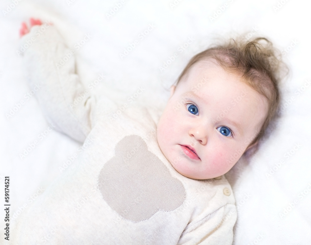 Funny little baby wearing a warm knitted sweater relaxing Funny little baby wearing a warm knitted sweater relaxing