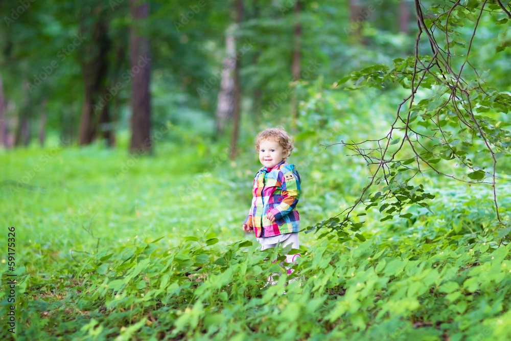 Adorable little girl playing in an autumn park Adorable little girl playing in an autumn park