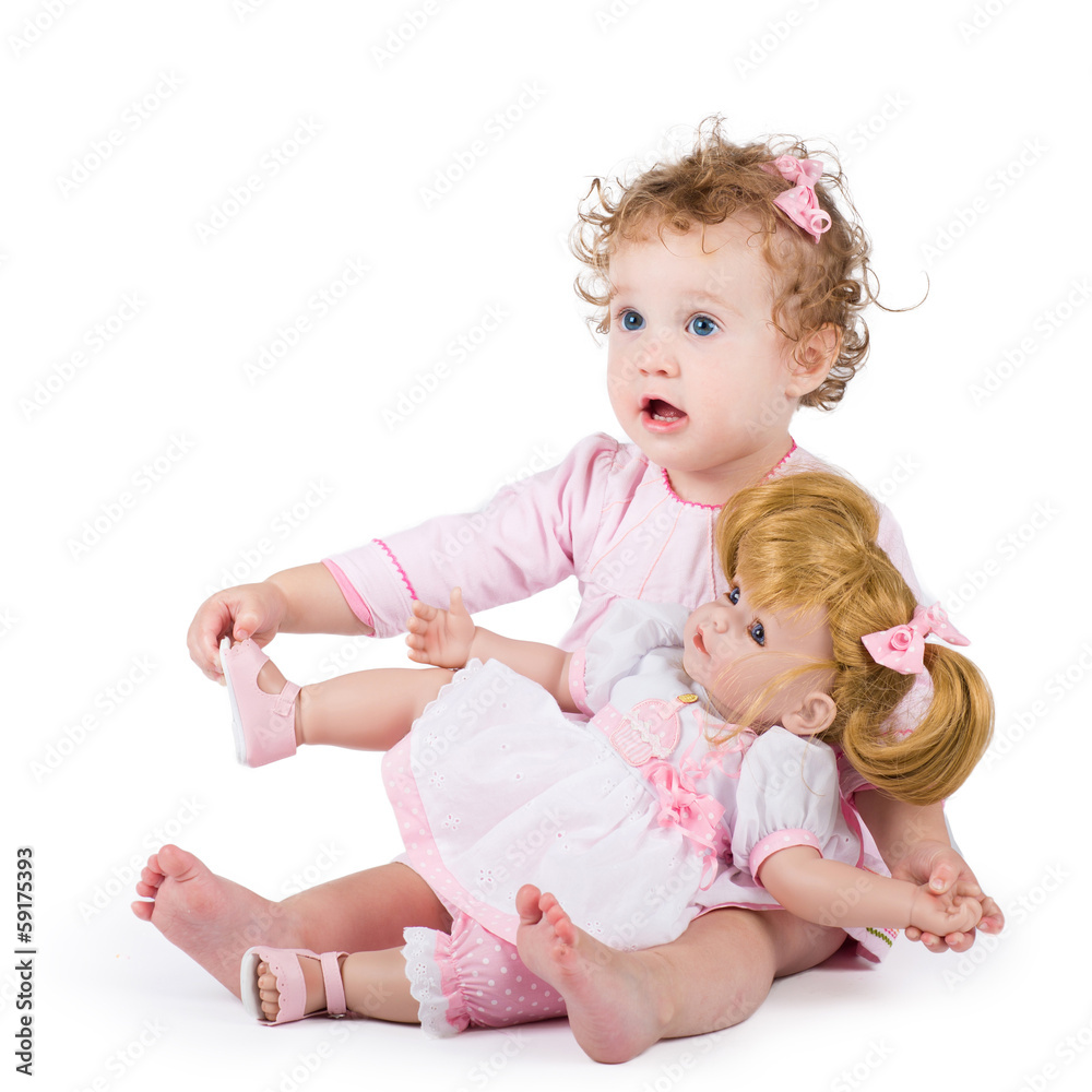 Cute toddler girl playing with her first doll Cute toddler girl playing with her first doll