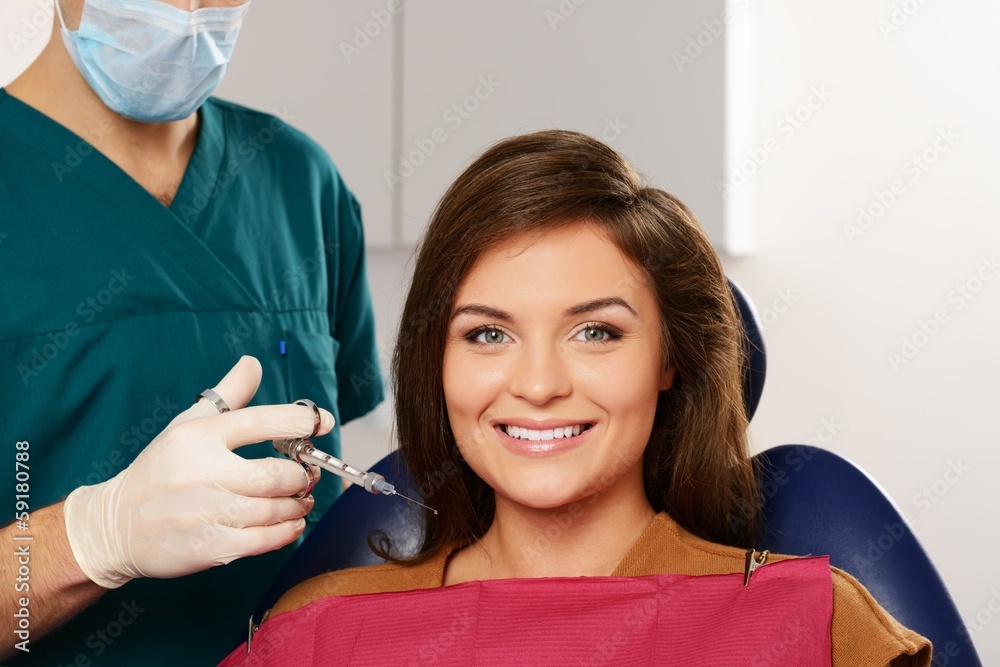 Dentist making anaesthetic injection to woman patient Stock Photo