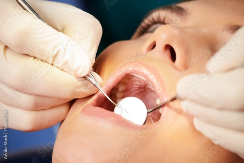 Young brunette woman at dentist s surgery close-up