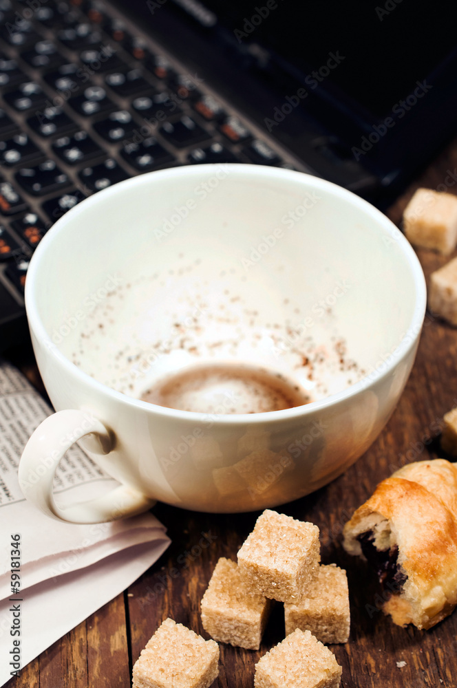 empty cup of coffee and a laptop on a wooden background empty cup of coffee and a laptop on a wooden background