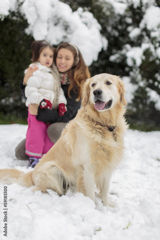 Family with a dog at snow
