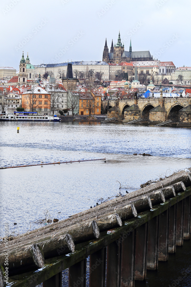 Obraz premium Romantic snowy Prague gothic Castle with the Charles Bridge